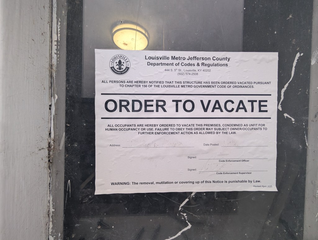 an order to vacate notice on an apartment door